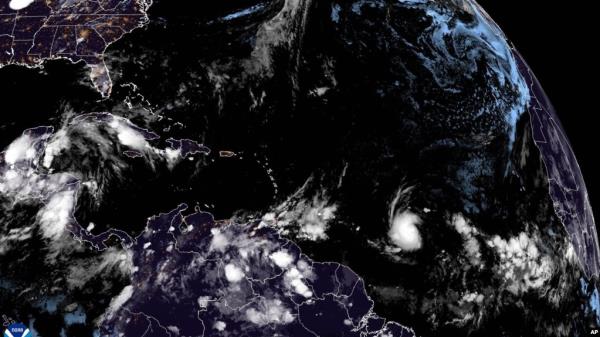 This Natio<em></em>nal Oceanic and Atmospheric Administration satellite image taken early on June 29, 2024, shows Tropical Storm Beryl, lower center right, as it strengthens over the Atlantic Ocean.
